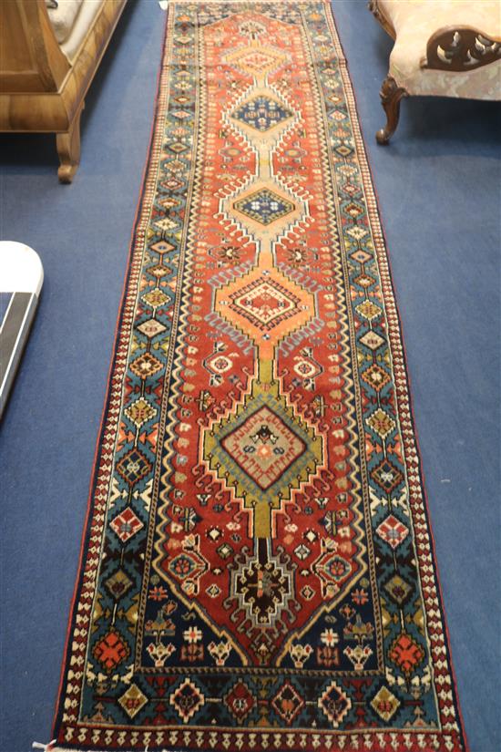 A Persian blue and russett runner, 325 x 77cm